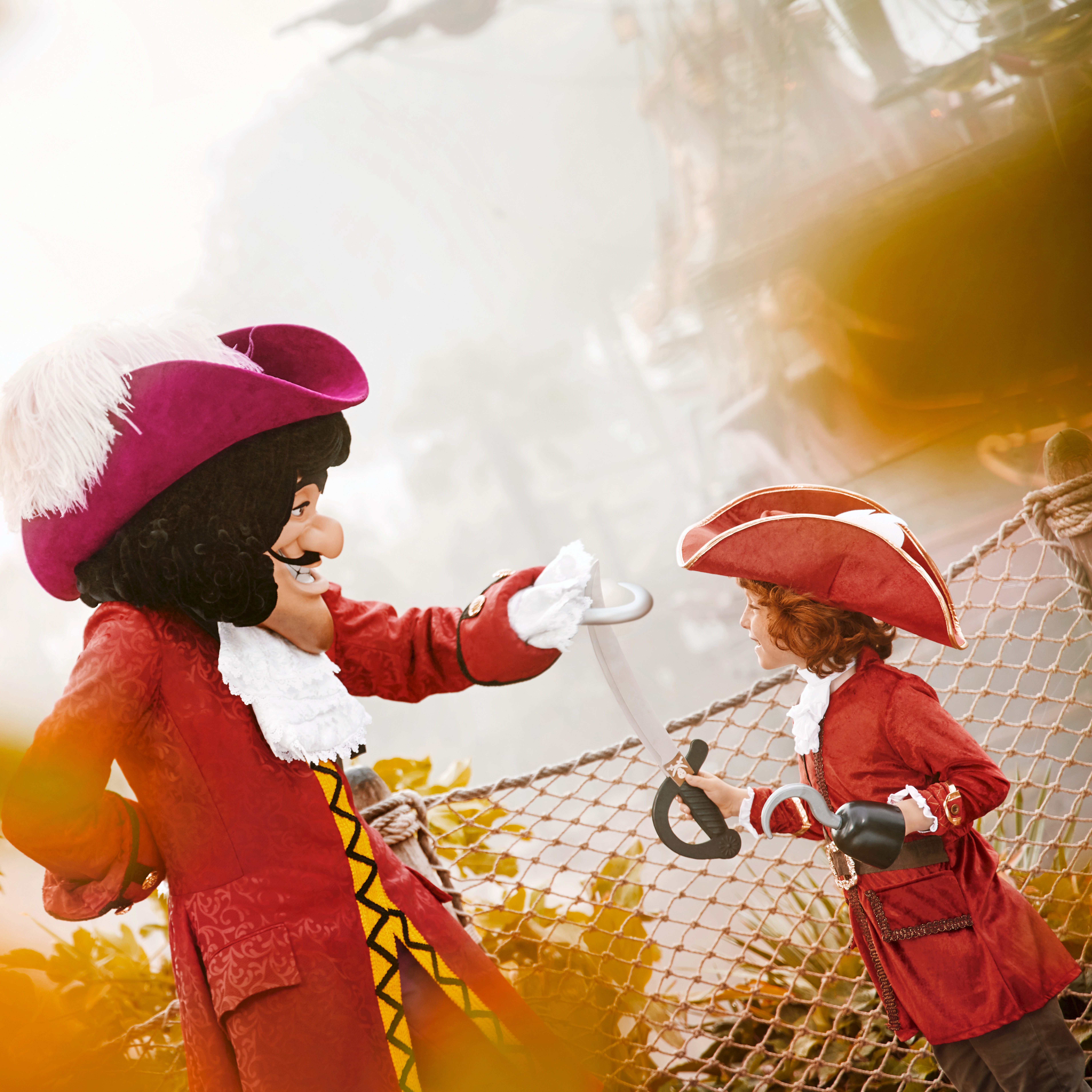 Costumed Captian Hook character interacting with child in pirate outfit